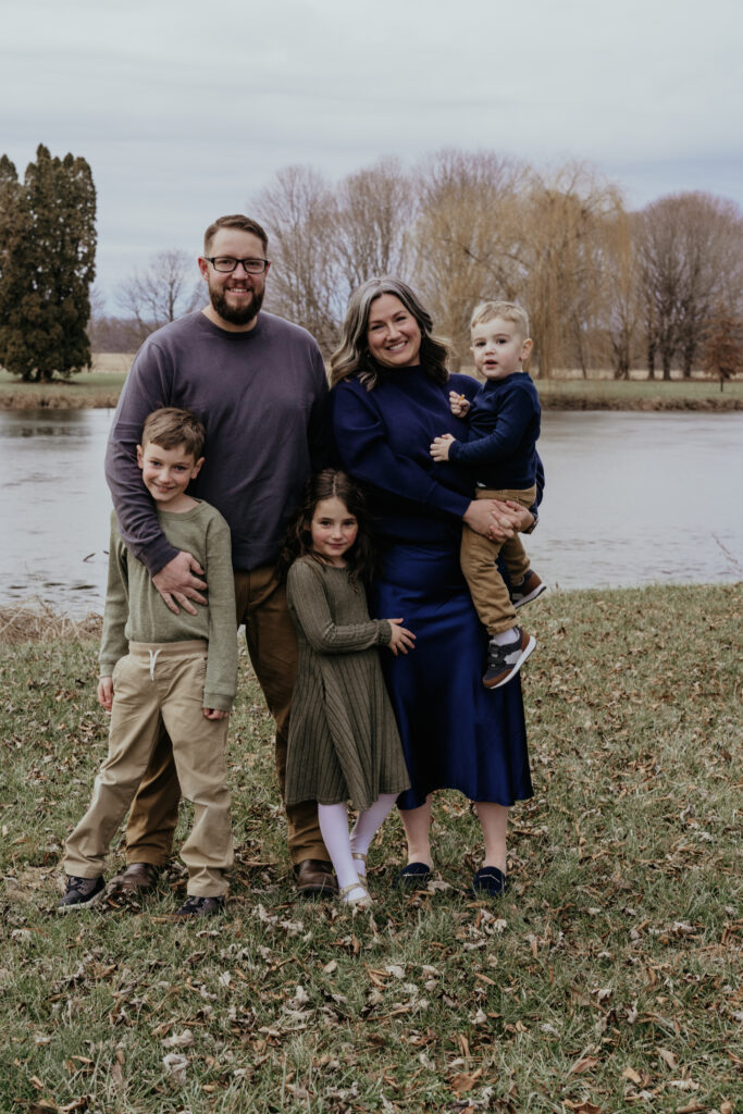 Photo of a young family in front of a lake