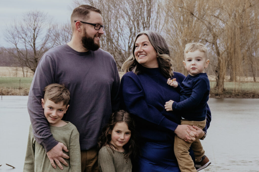 Photo of a young family in front of a lake