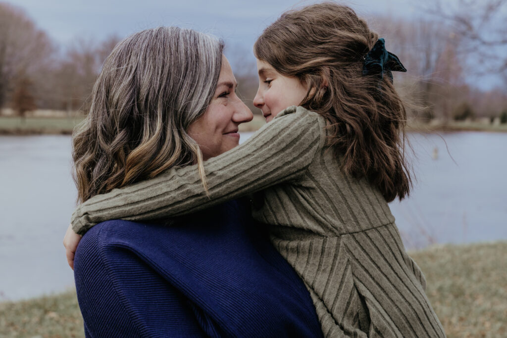 image of a mom and young daughter with their foreheads touching